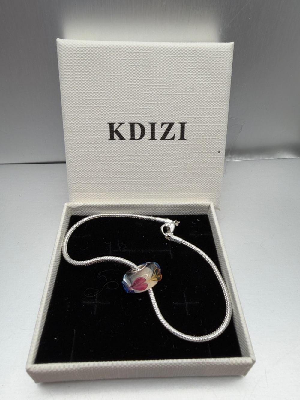 Silver snake chain bracelet and glass bead charm
